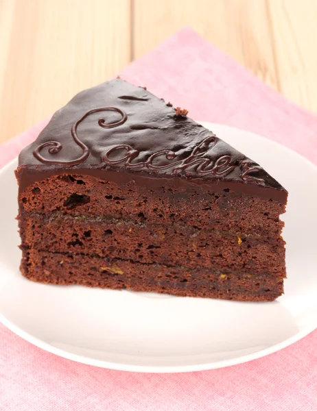 stock image Chocolate sacher cake on wooden table