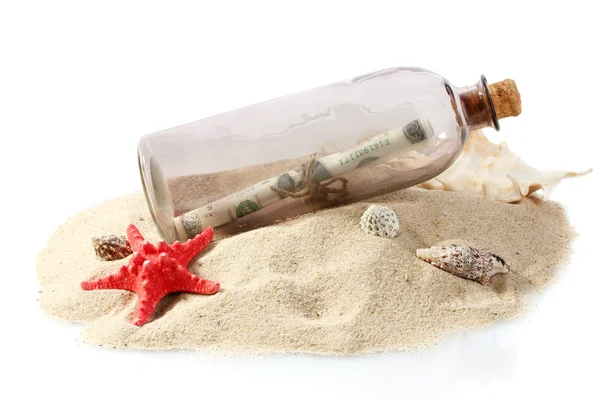 Glass bottle with note inside on sand isolated on white Royaltyfria Stockbilder