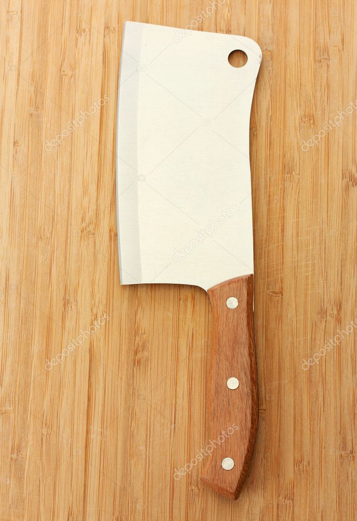 Meat cleaver on wooden background close-up