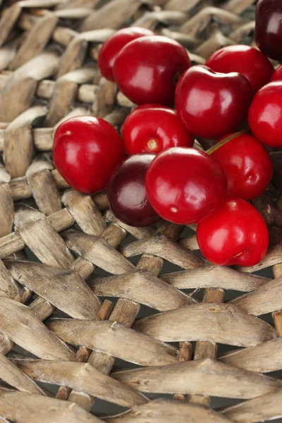 Cherry on the wicker cradle close-up — Stock Photo, Image