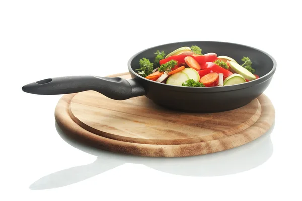 Frying pan with vegetables on white — Stock Photo, Image