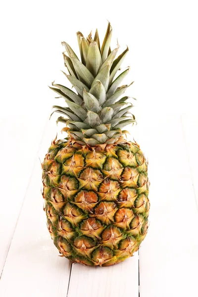 Pineapple on white wooden table — Stock Photo, Image