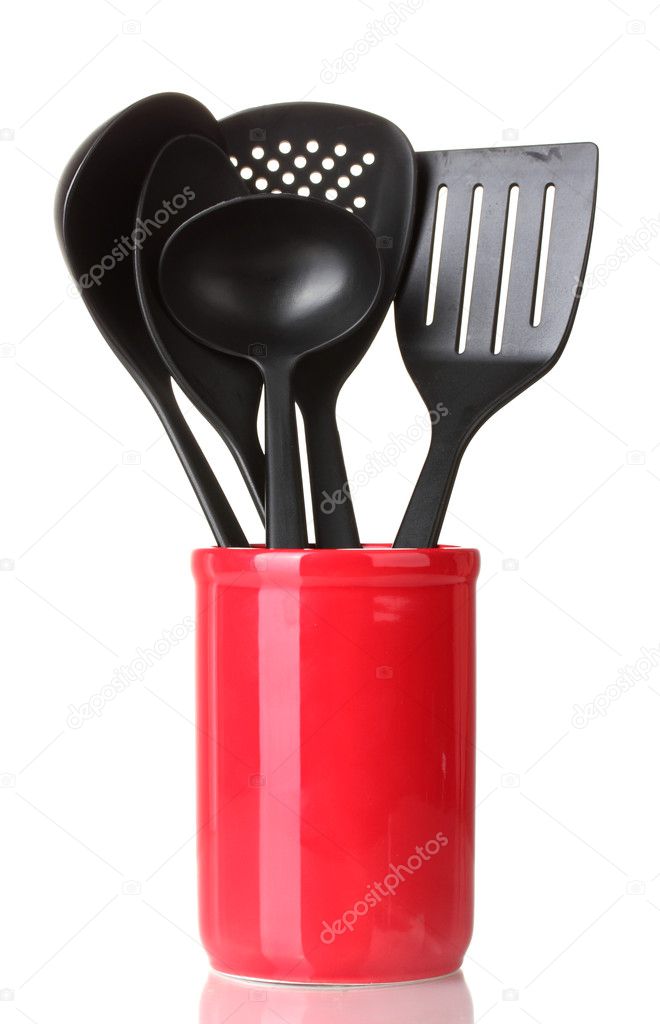 Black kitchen utensils in cup isolated on white