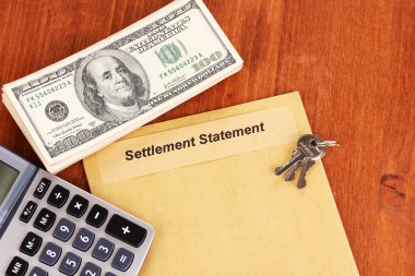 Folder with the settlement statement on wooden background close-up clipart