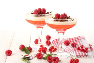 Fruit jelly with berries in glasses on wooden table clipart