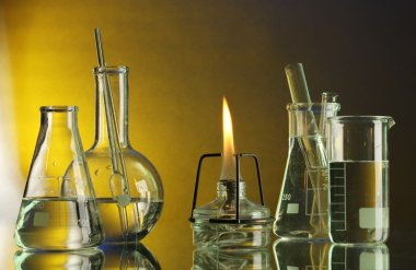 Spiritlamp and test-tubes on blue-yellow background