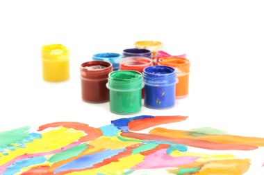 Jars with colorful gouache with a bright picture close-up clipart