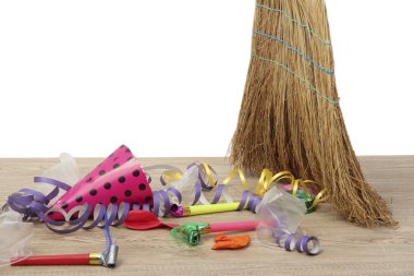 Broom sweep the trash after a party on white background close-up clipart