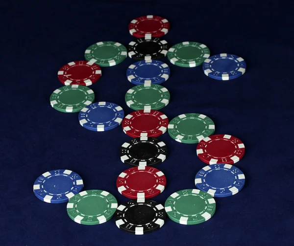 Poker chips in the form of dollars on a blue table — Stock Photo, Image