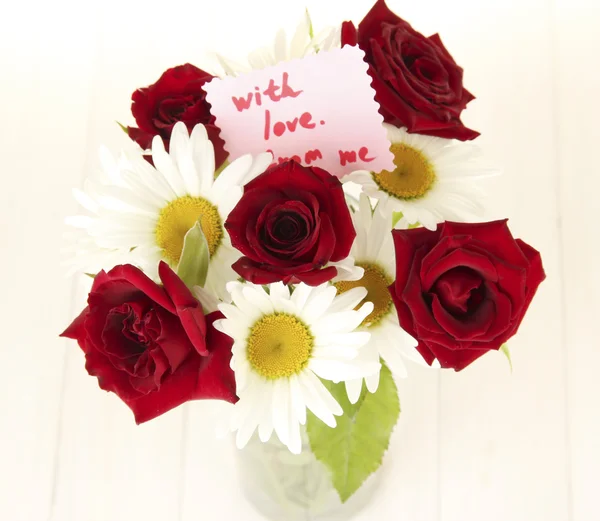 stock image Bouquet of roses and daisies with note isolated on white