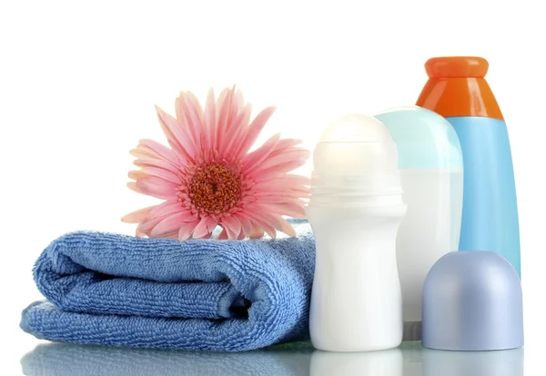 Cosmetics bottles with towel and flower isolated on white — Stock Photo, Image