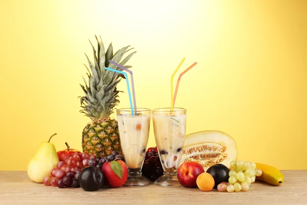 Milk shakes with fruit on yellow background close-up — Stock Photo, Image