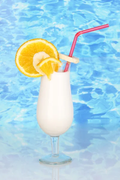 Läcker mjölk shake med frukt på bordet på blå havet bakgrund — Stockfoto