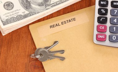 Folder with information of real estate on wooden background close-up clipart