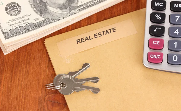 Folder with information of real estate on wooden background close-up — Stock Photo, Image