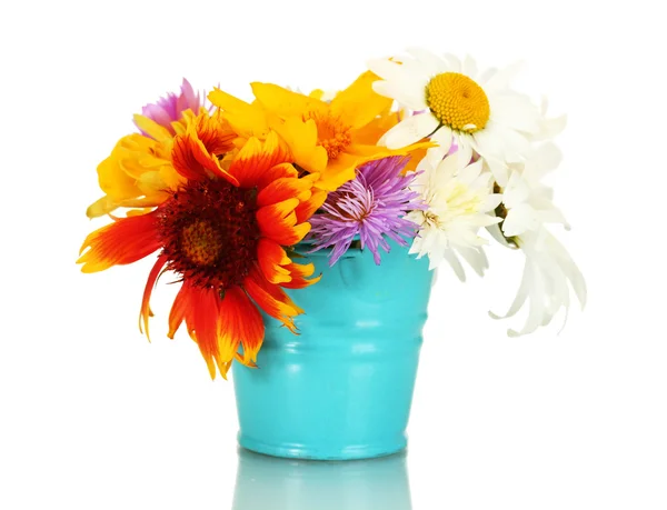 Beautiful bouquet of bright wildflowers in blue metal bucket, isolated on white — Stock Photo, Image