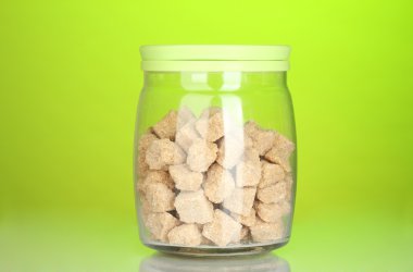 renkli arka plan üzerinde kahverengi şeker kamışı yumru ile jar