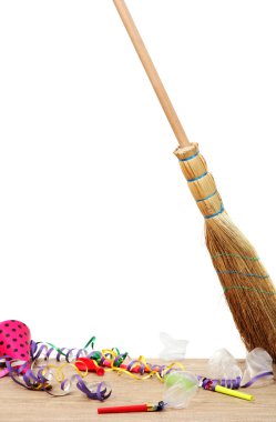 Broom sweep the trash after a party on white background close-up clipart