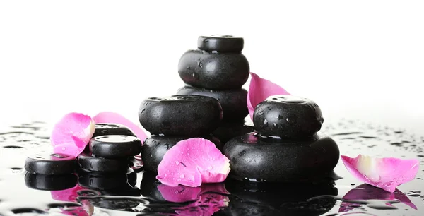 Spa stones with drops and rose petals on white background — Stock Photo, Image