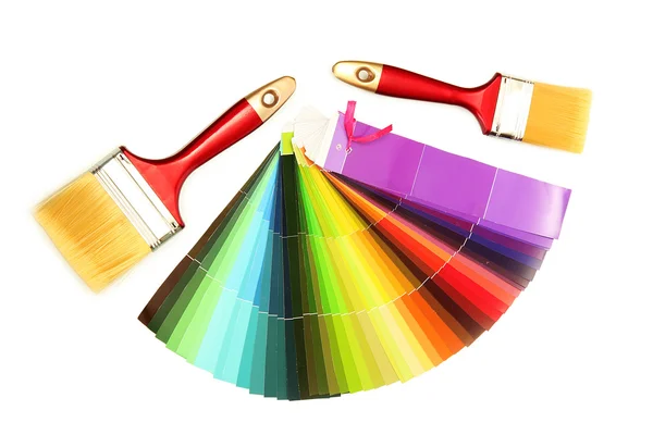 Paint brushes and bright palette of colors isolated on white — Stock Photo, Image