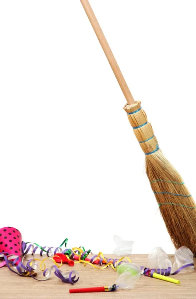 Broom sweep the trash after a party on white background close-up — Stock Photo, Image