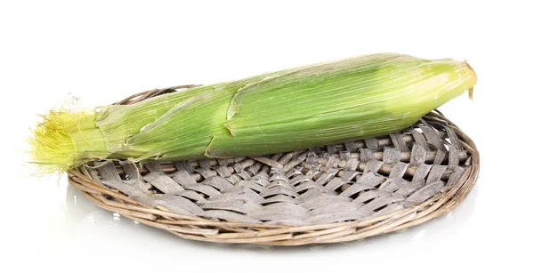 Fresh corn cob on wicker mat isolated on white — Stock Photo, Image