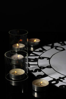 Spiritualistic seance by candlelight close-up clipart