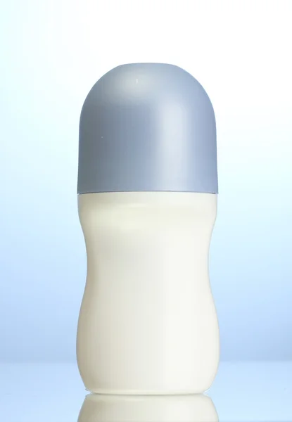 Deodorant on blue background — Stock Photo, Image