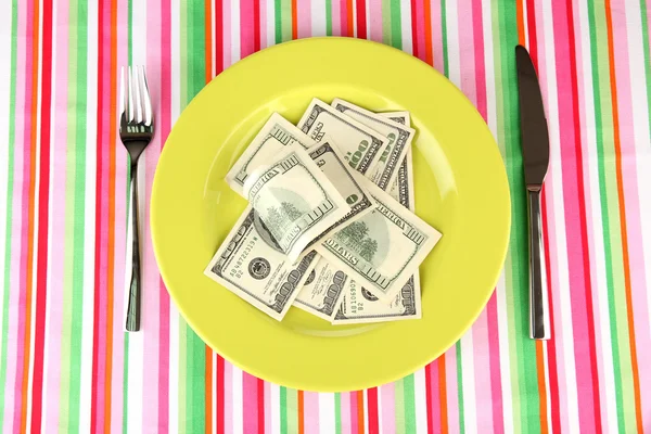 Banknotes on the plate on striped tablecloth close-up — Stock Photo, Image