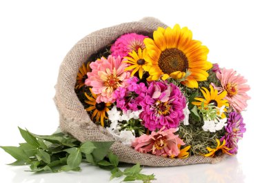 Beautiful bouquet of bright flowers in sacking isolated on white clipart