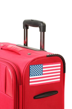 Red suitcase with sticker with flag of USA isolated on white