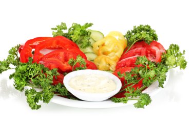 Chopped vegetables and sauce on plate isolated on white