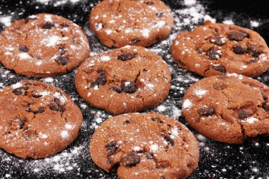 Chocolate chips cookies isolated on black clipart