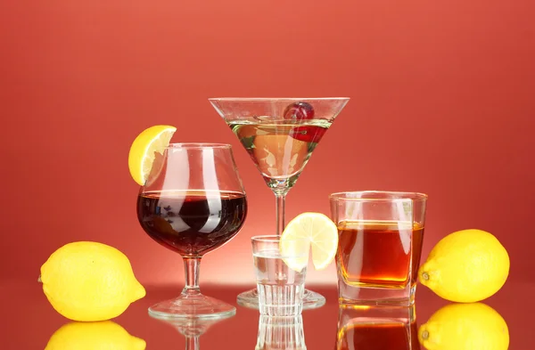 stock image A variety of alcoholic drinks on red background