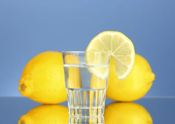 Shot of tequila on blue background close-up — Stock Photo, Image