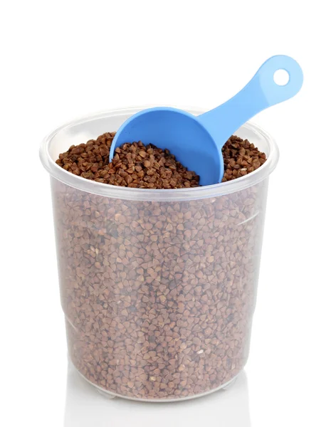 Measuring spoon and plastic container with grain isolated on white — Stock Photo, Image