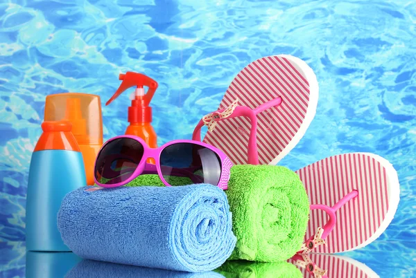 Bright beach accessories, on blue sea background — Stock Photo, Image
