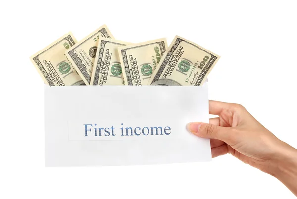 stock image Woman's hand holding an envelope with money on white background