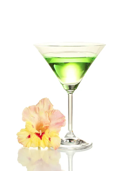 Glass with cocktail and gladiolus bud isolated on white — Stock Photo, Image