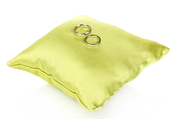Wedding rings on satin pillow isolated on white — Stock Photo, Image