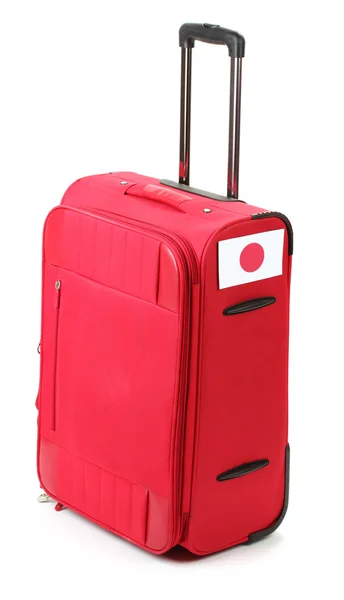 Valise rouge avec autocollant avec drapeau du Japon isolé sur blanc — Photo