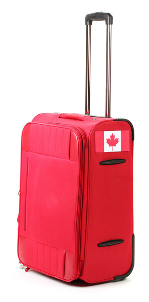 Red suitcase with sticker with flag of Canada isolated on white