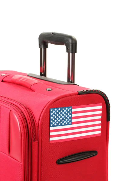 Red suitcase with sticker with flag of USA isolated on white — Stock Photo, Image