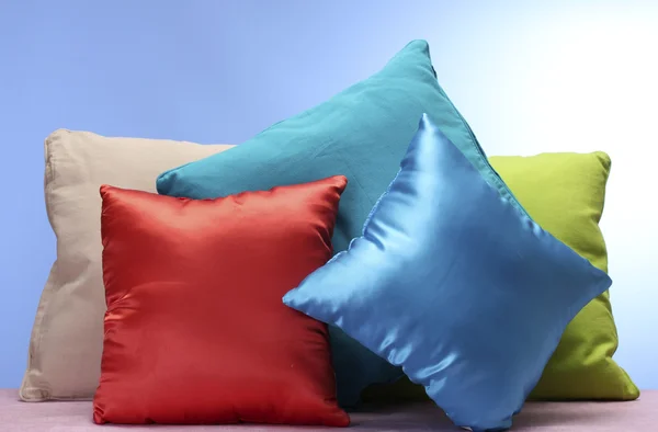 Bright pillows on blue background — Stock Photo, Image