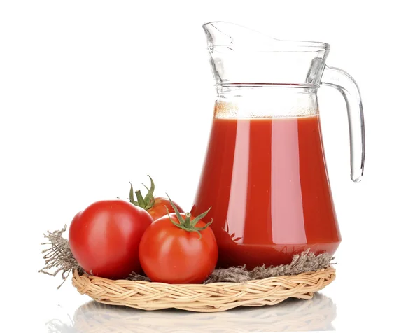 Tomato juice in pitcher on wicker mat isolated on white — Stock Photo, Image