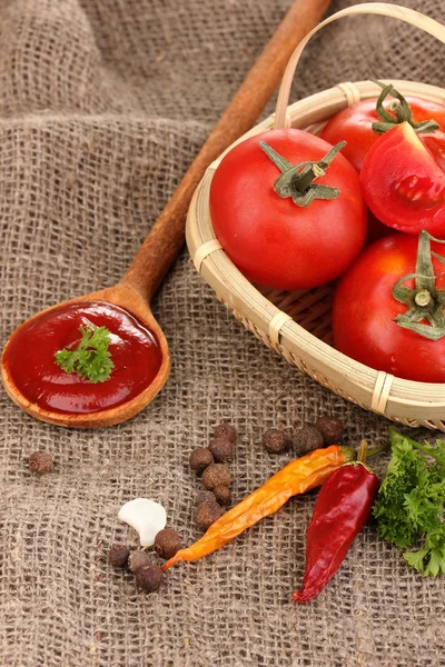 stock image Ketchup and ripe tomatoes on sacking close-up