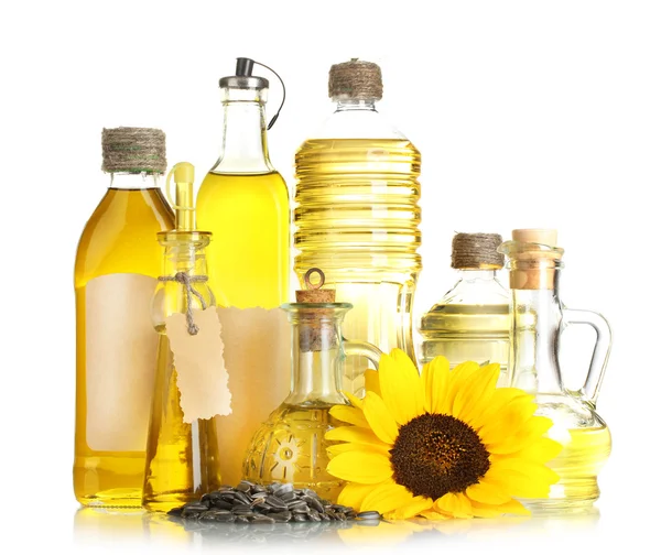 Олія в пляшках, соняшник і насіння, ізольовані на білому — стокове фото