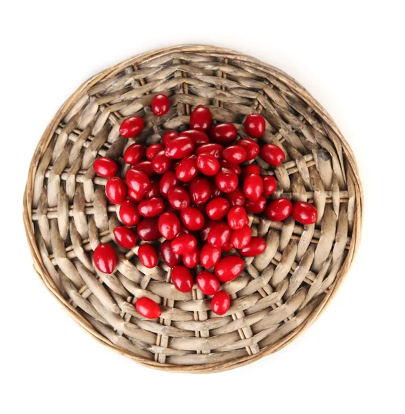 Fresh cornel berries on wicker mat isolated on white — Stock Photo, Image
