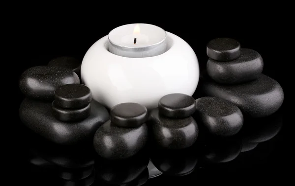 Spa stones with candle isolated on black — Stock Photo, Image