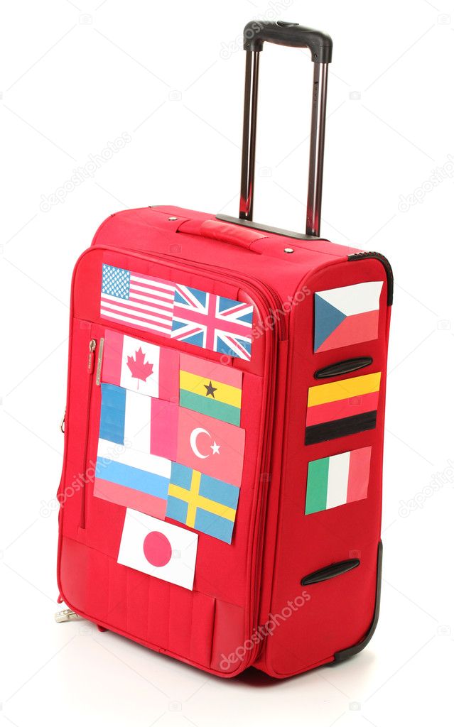 Red suitcase with many stickers with flags of different countries isolated on white